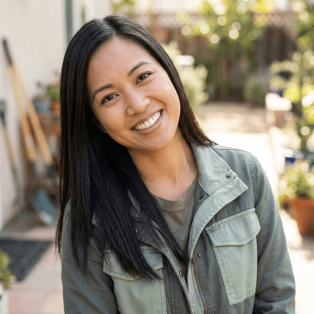 Priya Patel smiling while holding a bouquet